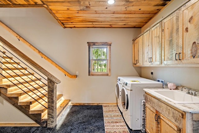 laundry area featuring washing machine and dryer, cabinet space, wood ceiling, baseboards, and recessed lighting