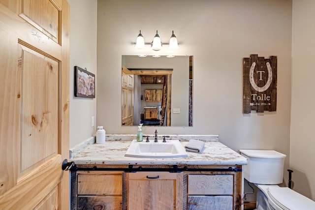 half bathroom featuring toilet and vanity