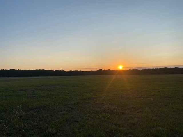 nature at dusk featuring a rural view