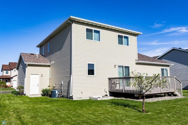 back of house featuring a wooden deck and a yard