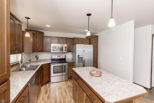 kitchen featuring stainless steel appliances, a sink, light countertops, and recessed lighting