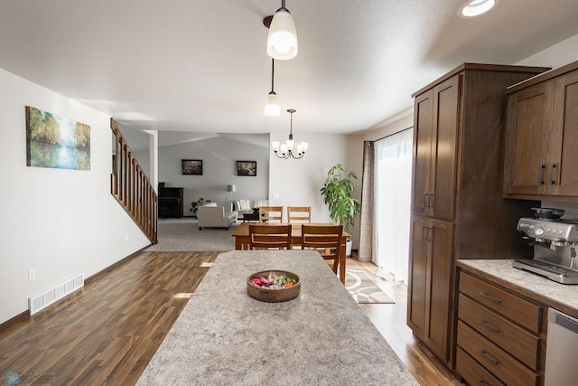 dining room with stairway, wood finished floors, a chandelier, and baseboards