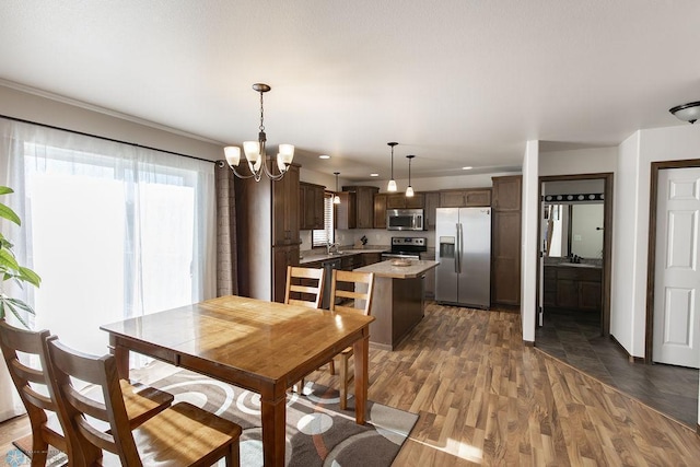 dining space featuring dark wood finished floors, a chandelier, and recessed lighting