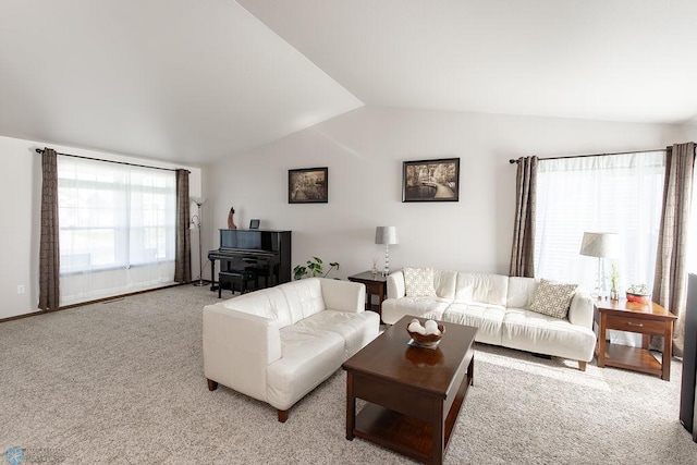 living area featuring vaulted ceiling and carpet flooring