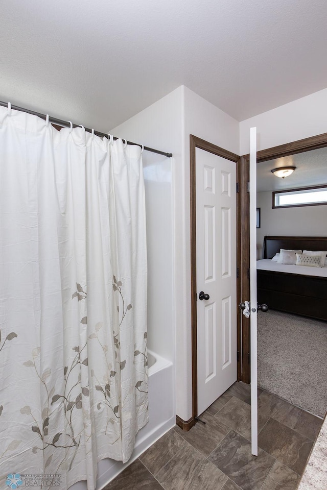 bathroom featuring ensuite bathroom and shower / tub combo with curtain