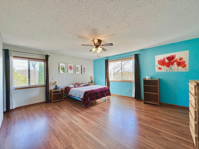 29441 108th St NW, Princeton, MN 55371 - bedroom featuring wood finished floors, ceiling fan, a textured ceiling, and baseboards