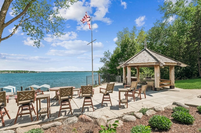 surrounding community with a gazebo and a water view