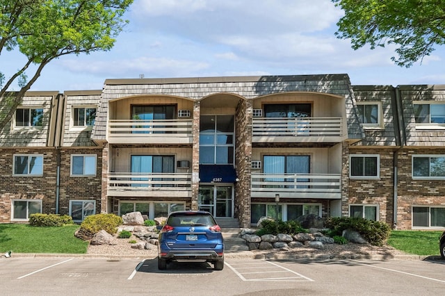 view of property featuring uncovered parking