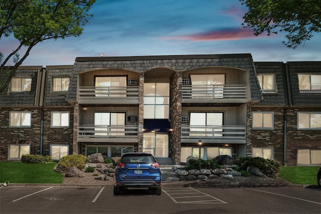 view of building exterior featuring uncovered parking