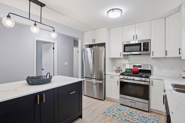 3544 Lee Ave N, Crystal, MN 55422 - kitchen featuring appliances with stainless steel finishes, tasteful backsplash, white cabinets, and dark cabinetry