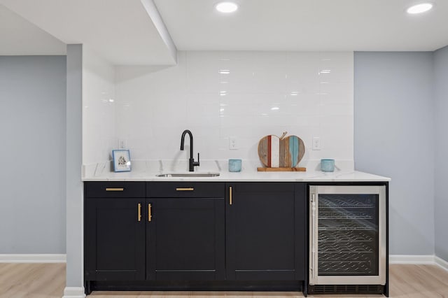 3544 Lee Ave N, Crystal, MN 55422 - indoor wet bar featuring wine cooler, baseboards, light wood-type flooring, tasteful backsplash, and recessed lighting