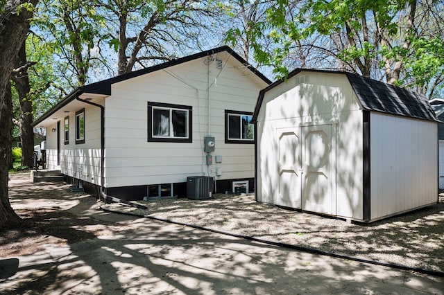 3544 Lee Ave N, Crystal, MN 55422 - back of house with a storage unit, an outbuilding, and central AC