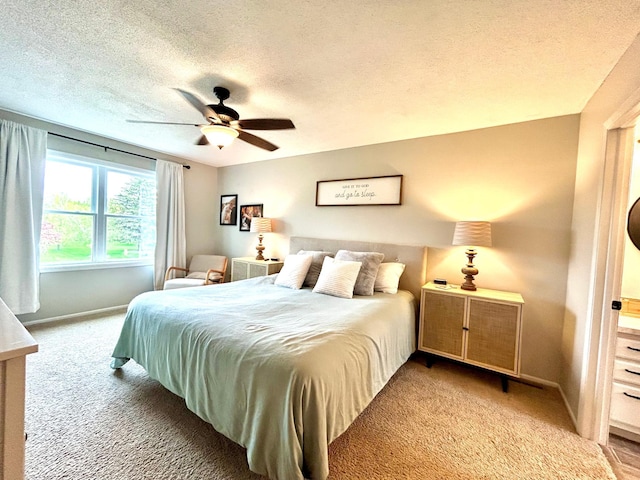 carpeted bedroom with baseboards, a textured ceiling, and ceiling fan