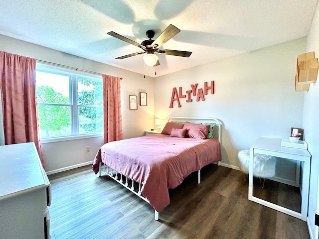bedroom featuring wood finished floors, baseboards, ceiling fan, and a textured ceiling