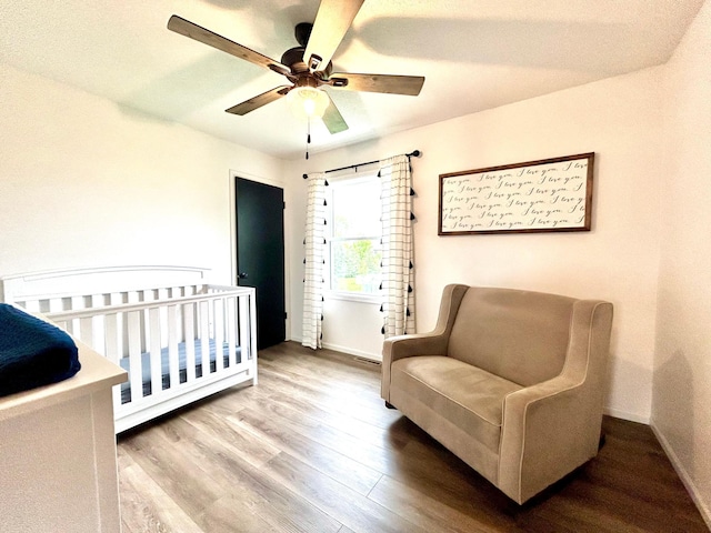 bedroom with wood finished floors, baseboards, and a ceiling fan