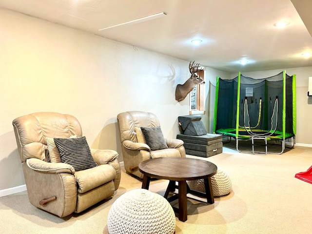 living area featuring recessed lighting, light carpet, and baseboards