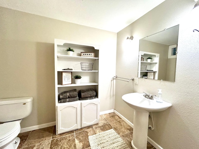 half bathroom featuring toilet