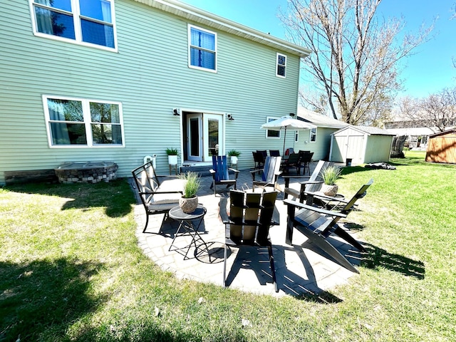 1921 Sherman Dr NW, Alexandria, MN 56308 - back of house with a patio, a lawn, and a fire pit