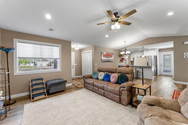 38760 Maple Ct, North Branch, MN 55056 - living room featuring wood finished floors, a ceiling fan, baseboards, a chandelier, and vaulted ceiling