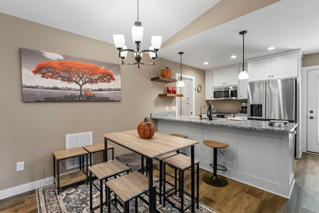 38760 Maple Ct, North Branch, MN 55056 - kitchen with appliances with stainless steel finishes, a peninsula, recessed lighting, baseboards, and dark wood-style flooring