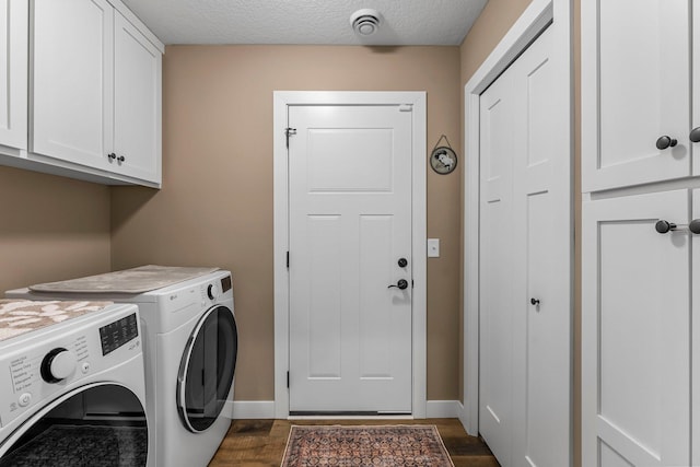 38760 Maple Ct, North Branch, MN 55056 - clothes washing area featuring washer and clothes dryer, cabinet space, dark wood-type flooring, baseboards, and a textured ceiling