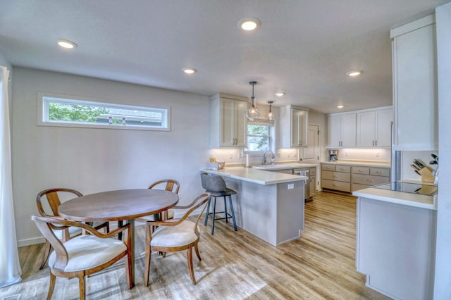 26533 Paradise Point Rd, Detroit Lakes, MN 56501 - kitchen with a peninsula, white cabinetry, light wood finished floors, light countertops, and recessed lighting