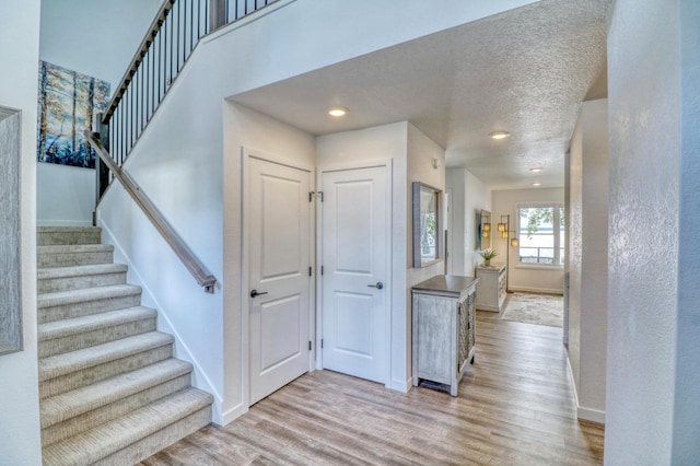 26533 Paradise Point Rd, Detroit Lakes, MN 56501 - entryway with baseboards, light wood finished floors, stairs, and recessed lighting