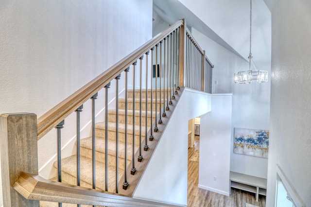 26533 Paradise Point Rd, Detroit Lakes, MN 56501 - stairs with wood finished floors, a chandelier, and a towering ceiling