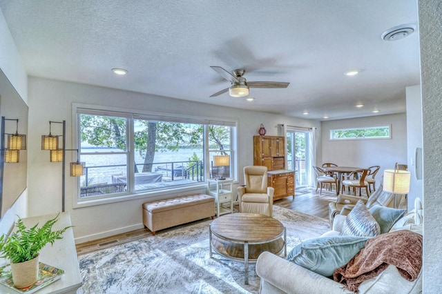 26533 Paradise Point Rd, Detroit Lakes, MN 56501 - living room featuring healthy amount of natural light, wood finished floors, ceiling fan, recessed lighting, and baseboards