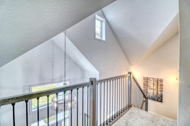 26533 Paradise Point Rd, Detroit Lakes, MN 56501 - hallway with carpet flooring, a chandelier, high vaulted ceiling, a textured ceiling, and an upstairs landing