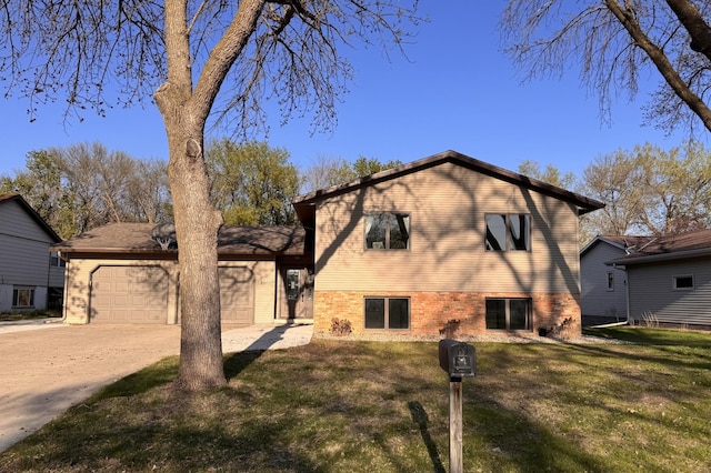 view of side of home featuring brick siding, an attached garage, driveway, and a yard