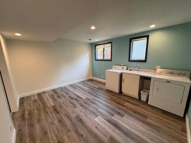 washroom with cabinet space, washer and clothes dryer, recessed lighting, and wood finished floors