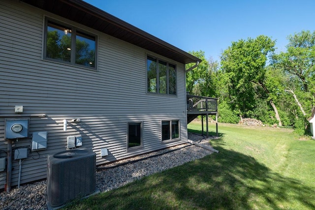 408 19th St NW, Willmar, MN 56201 - view of side of property featuring cooling unit, a yard, and a wooden deck