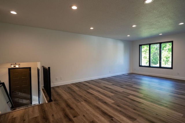 408 19th St NW, Willmar, MN 56201 - unfurnished room featuring recessed lighting, dark wood-style floors, baseboards, and a textured ceiling