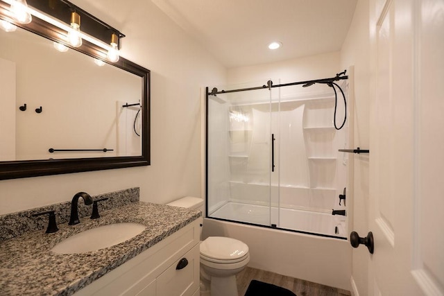 408 19th St NW, Willmar, MN 56201 - bathroom featuring toilet, vanity, combined bath / shower with glass door, and recessed lighting
