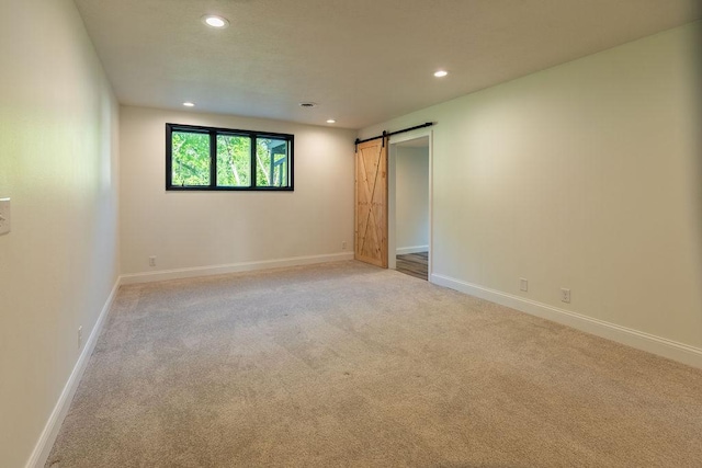 408 19th St NW, Willmar, MN 56201 - carpeted empty room with recessed lighting, a barn door, and baseboards