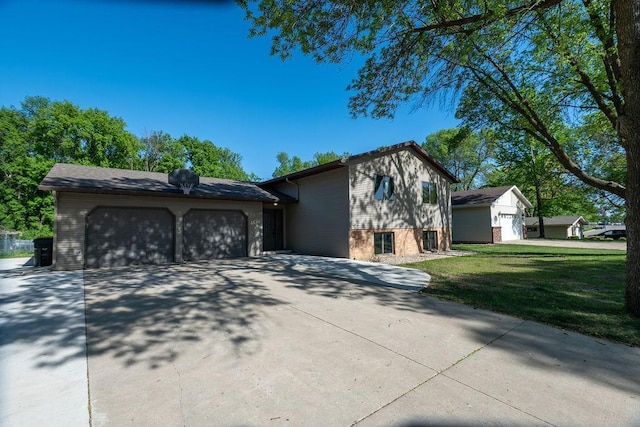 408 19th St NW, Willmar, MN 56201 - view of front of property featuring a garage, driveway, brick siding, and a front yard