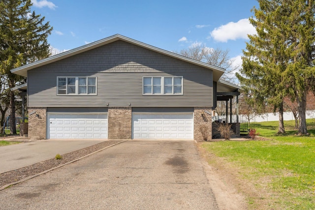 11110 Utica Ave S, Bloomington, MN 55437 - view of front of home featuring driveway, a garage, brick siding, and a front lawn