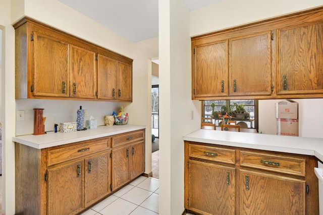 11110 Utica Ave S, Bloomington, MN 55437 - kitchen with brown cabinetry, light countertops, and light tile patterned flooring