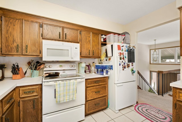 11110 Utica Ave S, Bloomington, MN 55437 - kitchen with white appliances, brown cabinets, light countertops, and light tile patterned floors