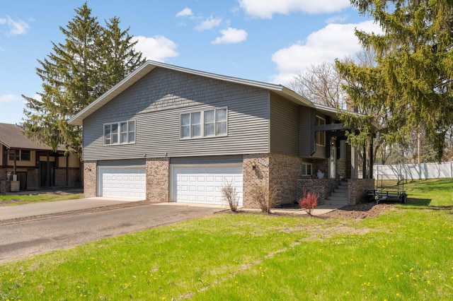 11110 Utica Ave S, Bloomington, MN 55437 - view of front of home with a garage, brick siding, and driveway