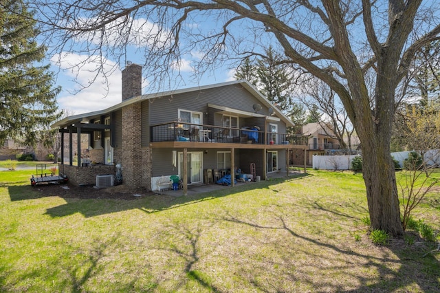 11110 Utica Ave S, Bloomington, MN 55437 - back of property featuring a chimney, a wooden deck, a lawn, and central AC