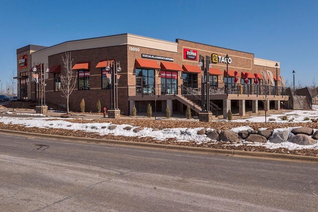 13560 Technology Dr Unit 1325, Eden Prairie, MN 55344 - snow covered property featuring view of commercial area and stairway