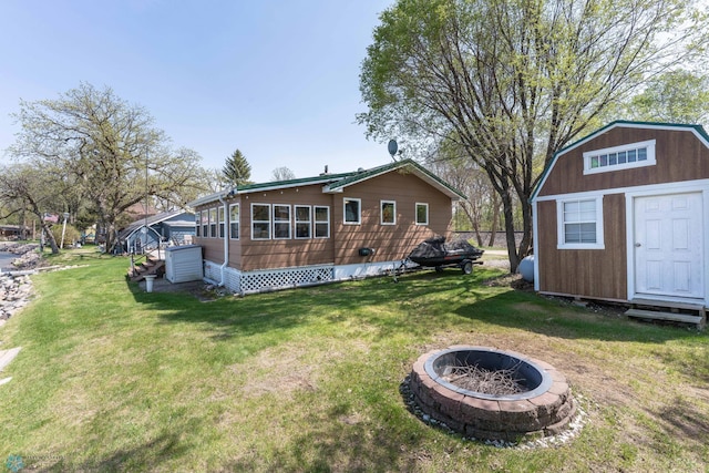 38603 Cozy Cove Rd, Dead Lake Twp, MN 56528 - back of property with a fire pit, a lawn, a shed, and an outdoor structure