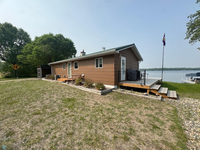 38603 Cozy Cove Rd, Dead Lake Twp, MN 56528 - rear view of house featuring a deck with water view, a lawn, and central AC