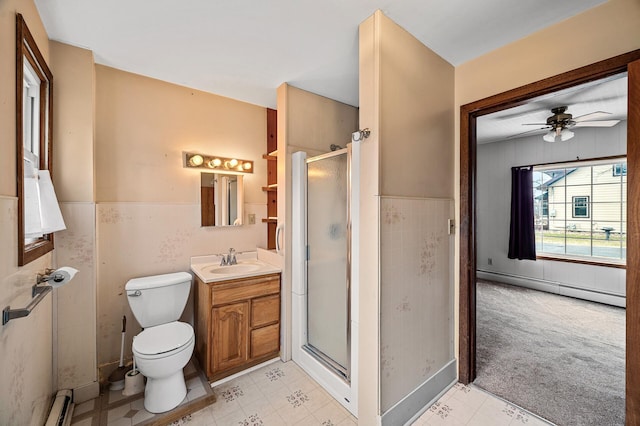 444 Vincent St, Saint Croix Falls, WI 54024 - bathroom with a baseboard radiator, a shower stall, vanity, ceiling fan, and toilet