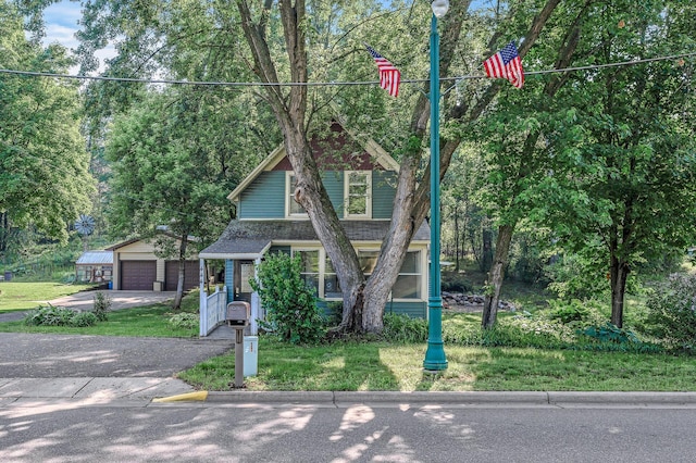 444 Vincent St, Saint Croix Falls, WI 54024 - view of front of home with a garage, an outdoor structure, and a front yard