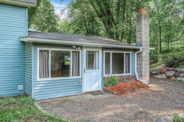 444 Vincent St, Saint Croix Falls, WI 54024 - view of exterior entry featuring a chimney