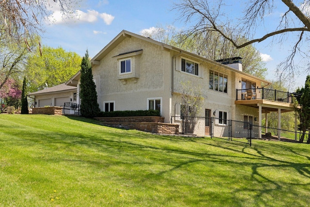 back of property featuring a chimney, a gate, stucco siding, and a balcony