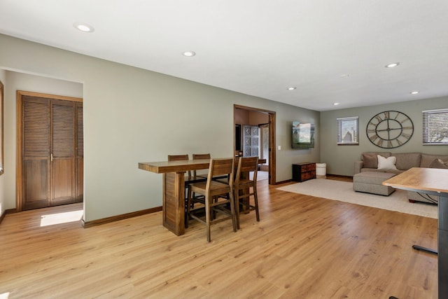 dining room featuring baseboards, light wood-style floors, and recessed lighting